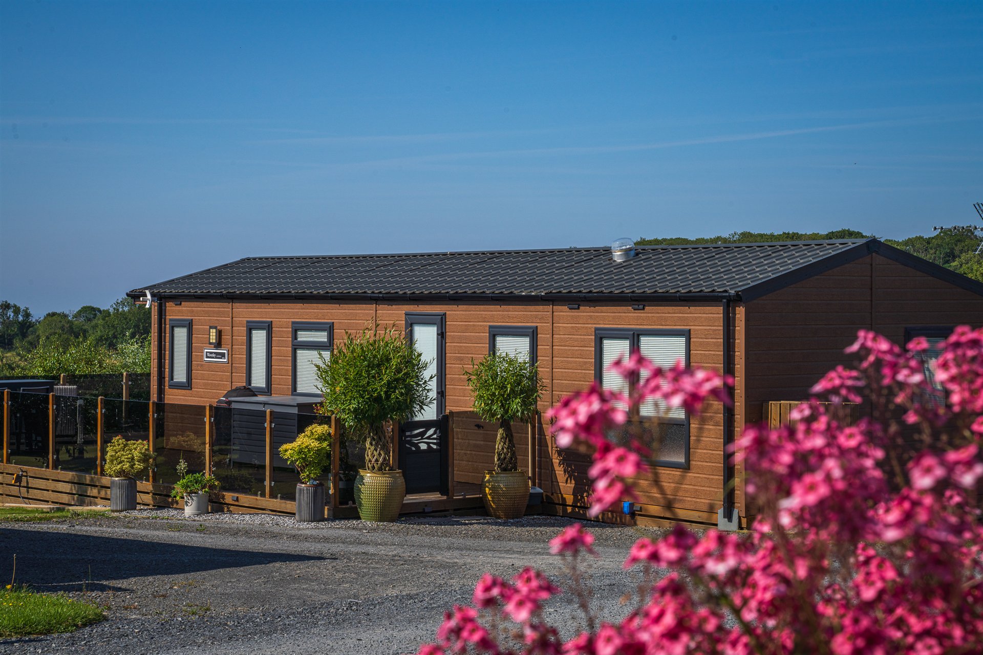 Holiday home framed by colourful planting at Lingwood Park